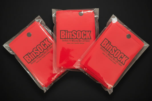 Three red 'BinSOCK' bags in clear packaging on a black background